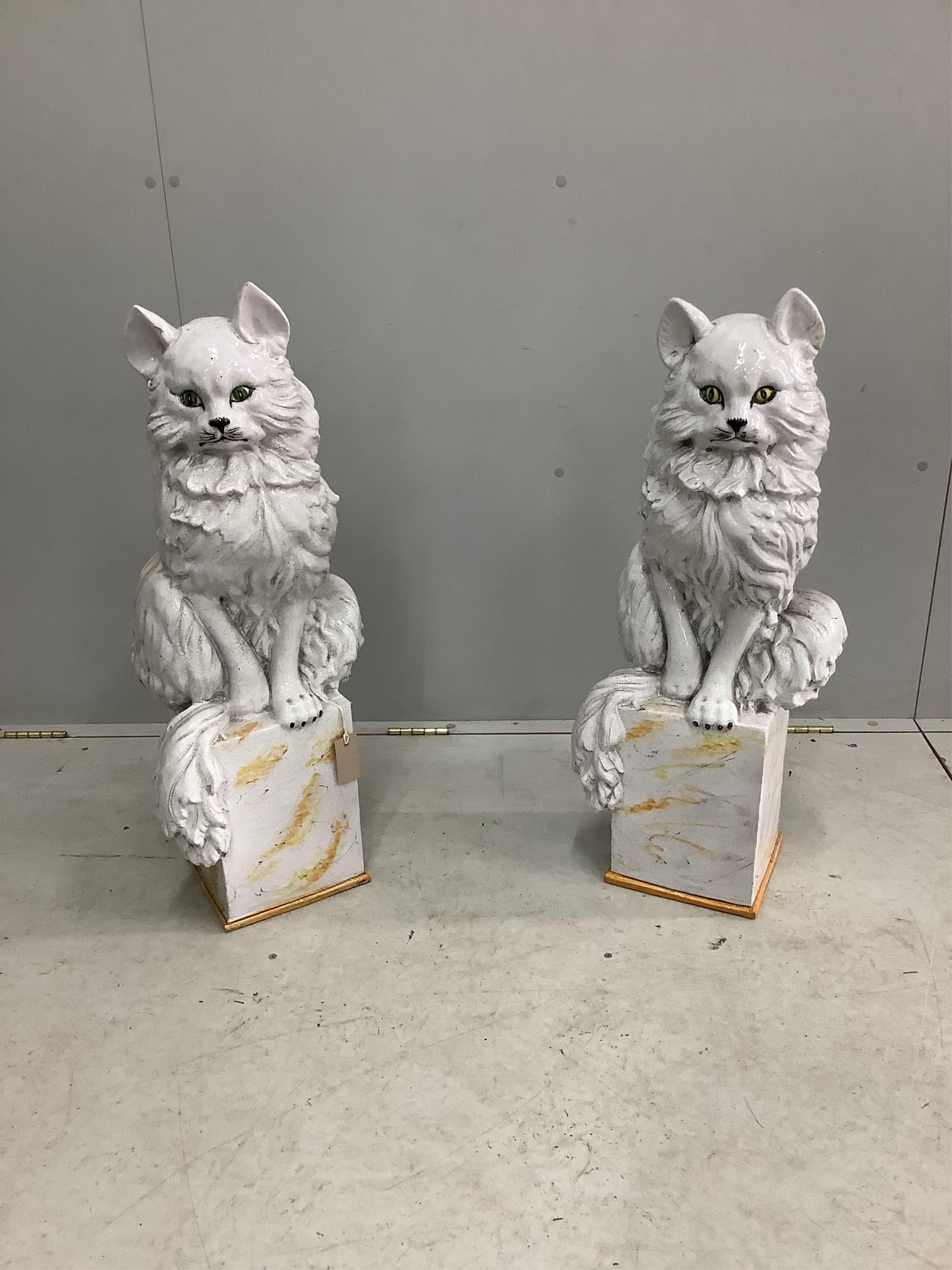 A pair of Italian white glazed ceramic models of seated cats, height 83cm. Condition - fair to good